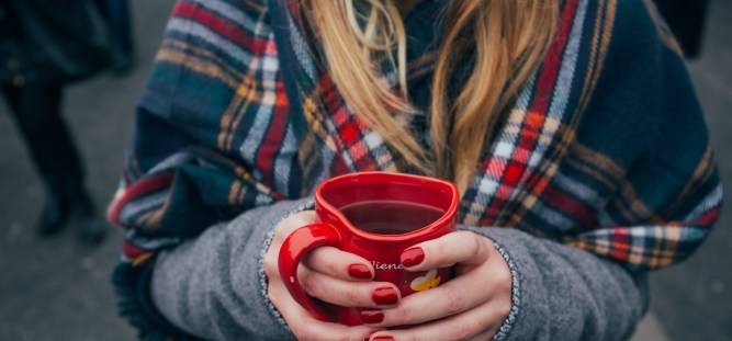 woman with red coffee cup